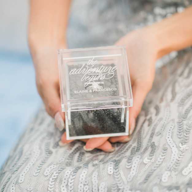 bride holding a clear acrylic ring box