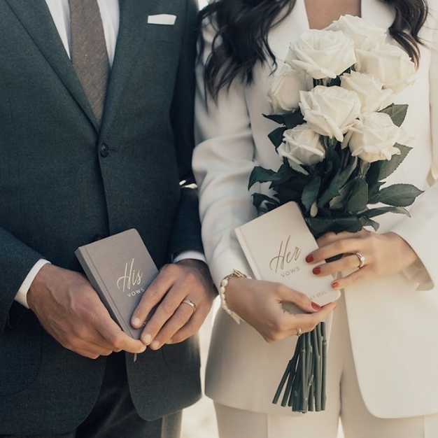 inspiration - bride and groom each holding vow journals